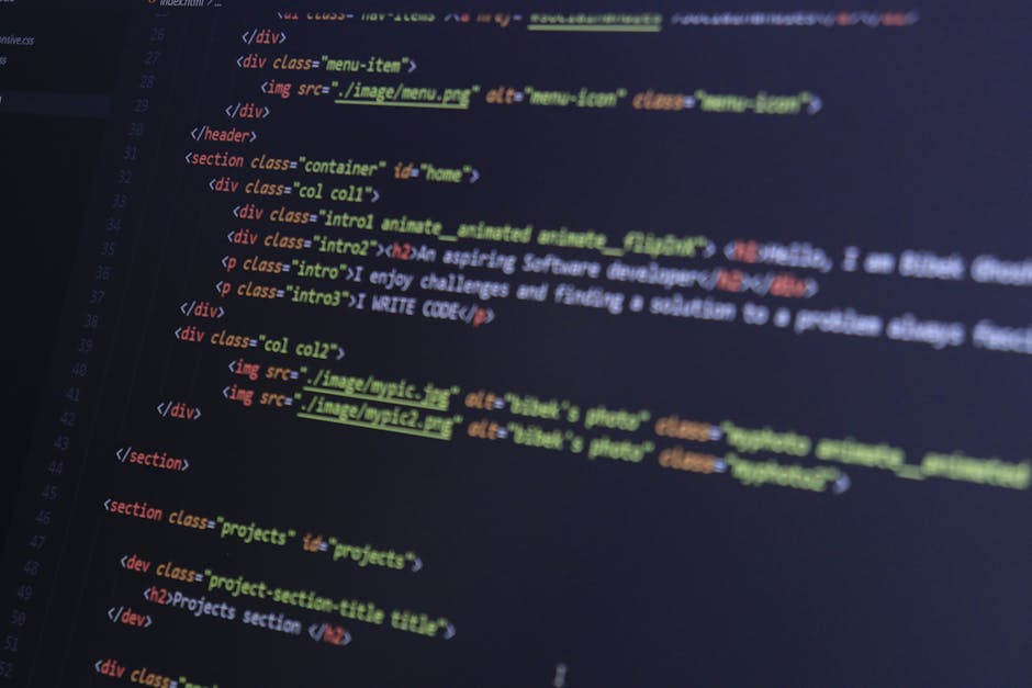 Close-up view of a computer screen displaying lines of HTML code in a black background with text highlighted in green, pink, and white. The code consists of nested tags, links, and attributes related 